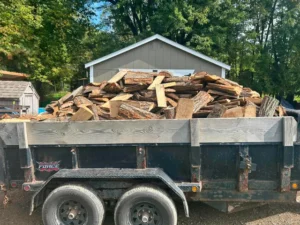 Dump trailer heaped with split hardwood ready for firewood delivery in Laingsburg, Michigan