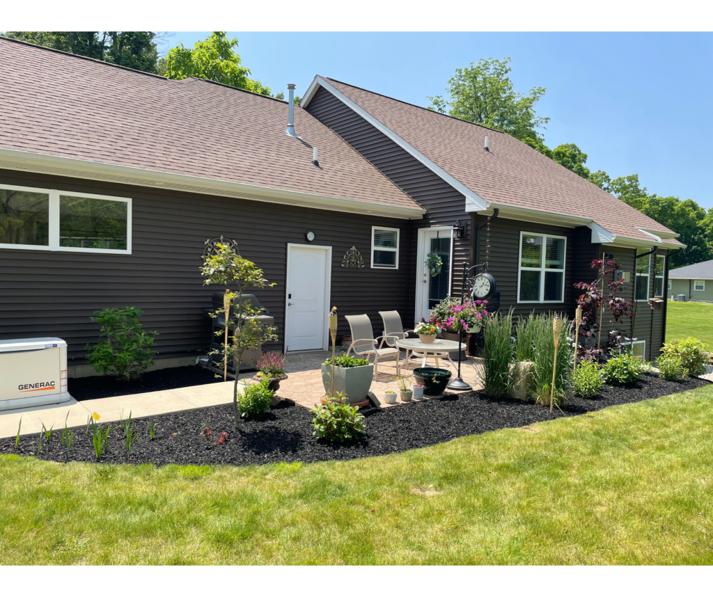 Newly planted landscape bed and patio edge at a modern home near Laingsburg, Michigan