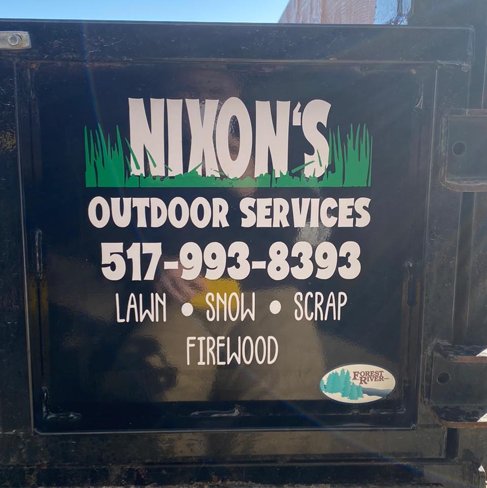 Nixon's Outdoor Services sign listing lawn, snow, scrap and firewood services in Laingsburg, Michigan
