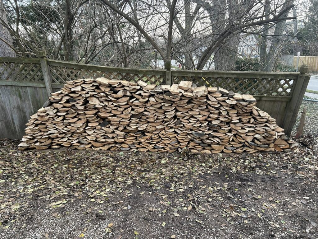 Large pile of split hardwood seasoning before firewood delivery in Laingsburg, Michigan