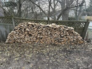 Large pile of split hardwood seasoning before firewood delivery in Laingsburg, Michigan